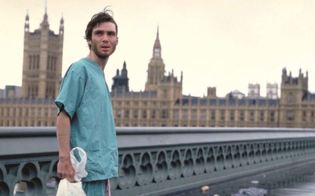 Jim (Cillian Murphy) wakes up to discover he's in the middle of a zombie apocalypse in 28 Days Later 2002. 